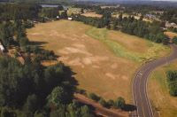 Open field with road, rail tracks