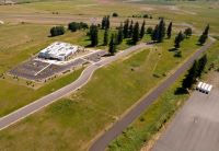 Open field next to building and road