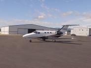 Parked plane outside hangar building