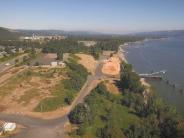 Aerial of river with dock, land, highway