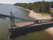 Shipping dock on the river, beach and trees