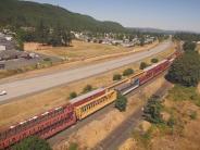 Train, highway, houses in background