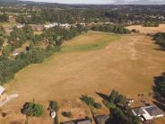 Open field with houses in background