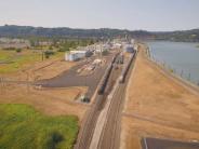 Train, rail tracks, industrial buildings, river