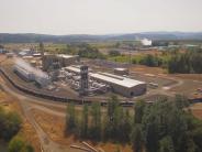 Train, rail tracks, industrial buildings, river