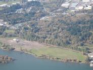 Aerial photo of river and land with trees and buildings