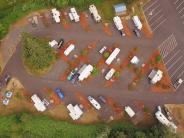 Aerial of campground with RVs, trees, parking lot