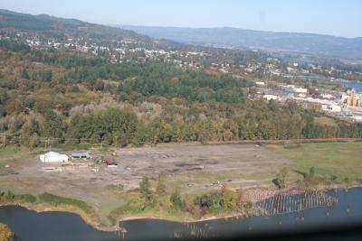 Aerial photo of land, a small building, and river front