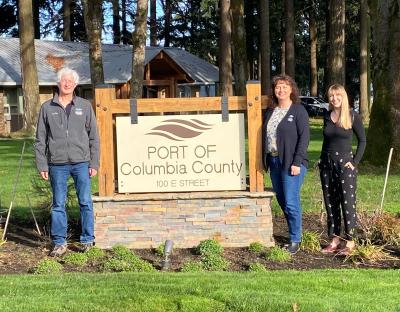 From left, Elliot Levin, Gina Sisco and Amy Bynum standing next to Port of Columbia County sign